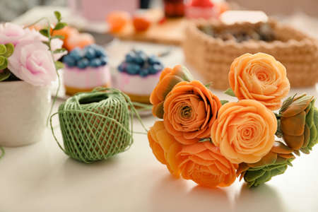 Girl makes flowers from the soap. Hobby, creative process. DIY gifts. Women's hands and flowers. Handmade soap. Mother's Day, Women's Day. Natural organic products. Flowers on a white table.の写真素材