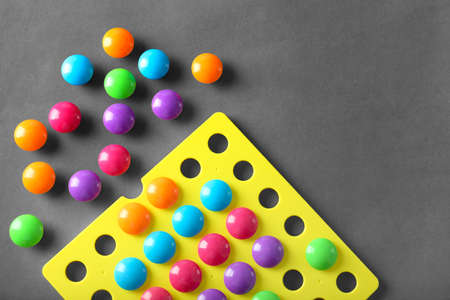 Circles of different colors, mosaic. Early development concept. Toys in a child's life, exploring colors. Activities with the baby. Preparing for kindergarten. Conscious matry. High quality toys for children.の写真素材