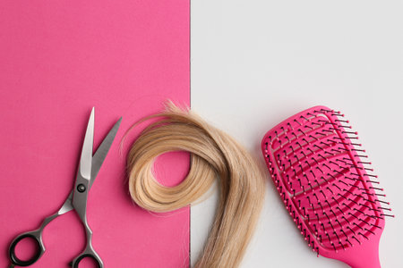 Flat lay composition with light blond hair, comb, scissors and space for text on background. Hairdresser serviceの写真素材