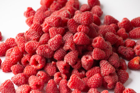 A handful of raspberries on a white background close-up. Useful berry isolated.の写真素材