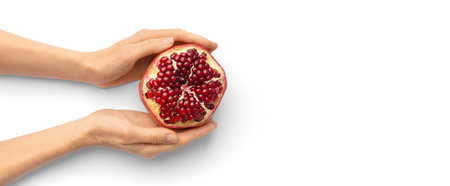Ripe peeled pomegranate in hands on a white background top view. A whole pomegranate with a cut peel in the palms on the isolation. healthy fruits.の写真素材
