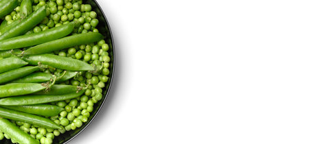 Fresh green peas in pods and peeled green pea seeds in a black round plate, isolated on white background, top view. Vegetable protein, healthy products.の写真素材