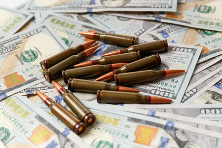 Combat army bullets, cartridges lie on American dollar banknotes, the concept of arms trade,...