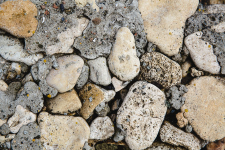 Pebbles mixed with the remains of cement cement close up. Top view