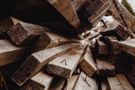 A pile of used wooden planks with nails sticking outの写真素材