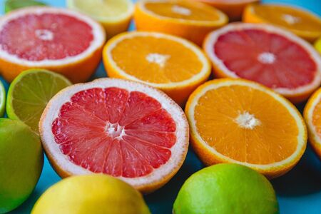 Colorful sliced citrus - oranges, grapefruits, lemons and limes close-up. Filled frameの写真素材