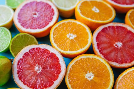 Colorful juicy sliced citrus - oranges, grapefruits, lemons and limes close-up. Filled frameの写真素材