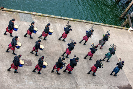 A Scottish band acts as host upon arrival of transatlantic ships in the port of Invergordon in...