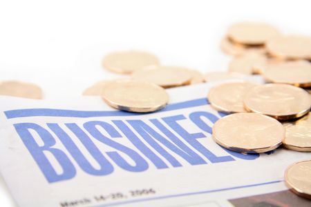 golden coin on the business pages of a newspaper.の写真素材