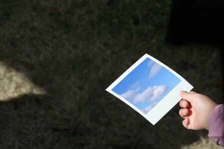 child hand hold a photo, concept of futureの写真素材