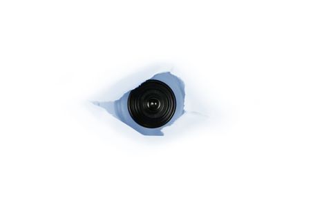 web cam behind a paper hole, concept of spyの写真素材