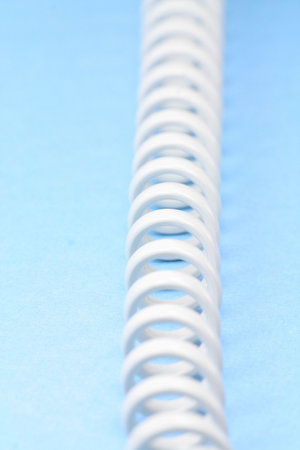 spiral telephone cable close up with a blue background