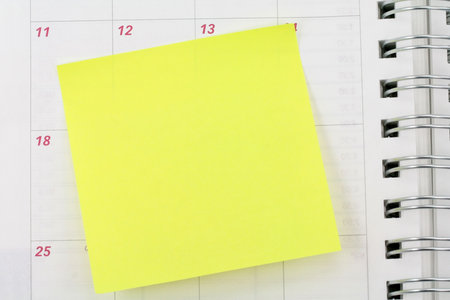 blank notepaper sticking on calendar