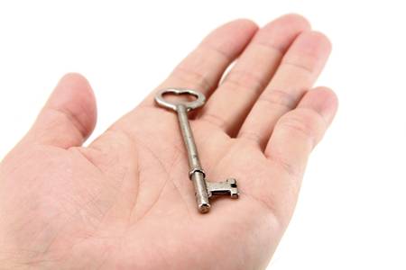 hand holding key with white background, concept of success, or real estateの写真素材