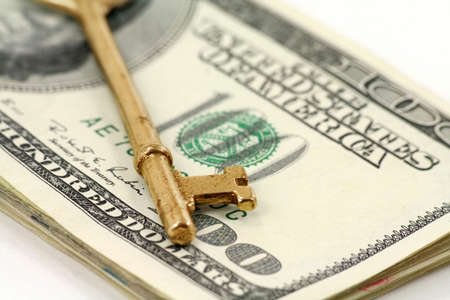 gold key and dollars, concept of successの写真素材