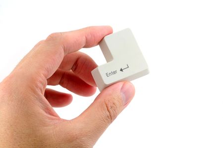 hand holding the enter key, concept of success or computer securityの写真素材