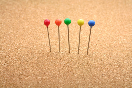 corkboard and colorful pins close upの写真素材