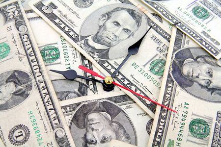 clock and dollars, concept of time is moneyの写真素材