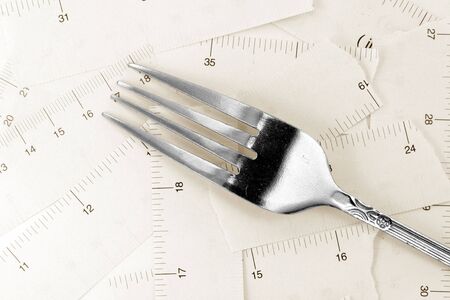 Tape Measure and fork, concept of dietの写真素材
