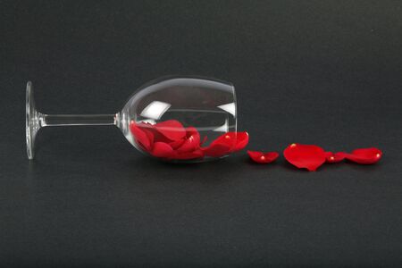rose petals in a wine glass with black background, love conceptの写真素材