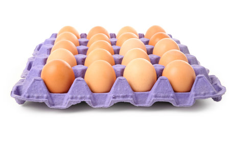 brown eggs in carton with white background