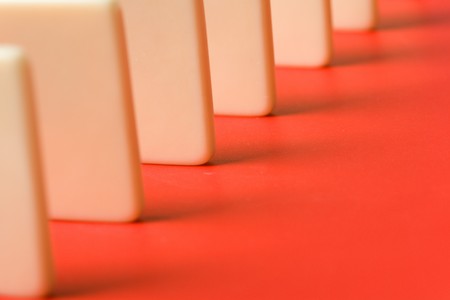 Domino with red background, Concept of Cause or Teamworkの写真素材