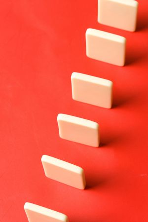 Domino with red background, Concept of Cause or Teamworkの写真素材