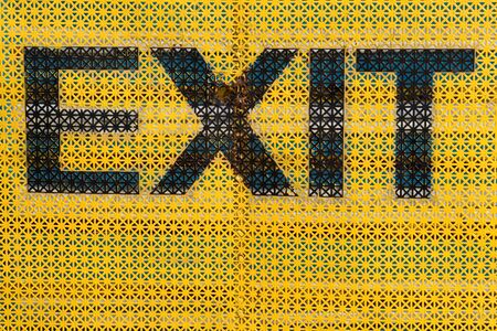 Exit Sign with yellow backgroundの写真素材