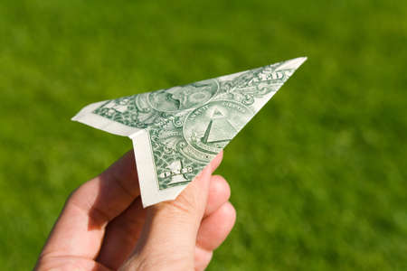 US Dollar Airplane and green grass, concept of Environmental Conservationの写真素材