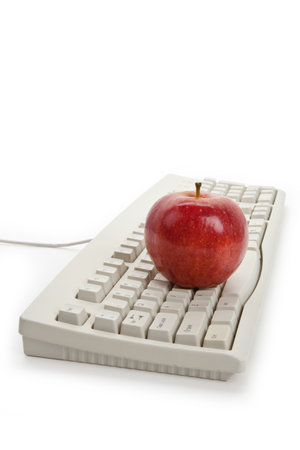 Computer Keyboard and red apple close up