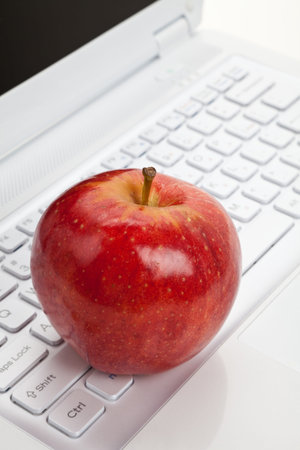 Computer Keyboard and red apple close up