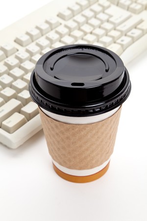 Disposable Coffee Cup and Computer Keyboard with white backgroundの写真素材