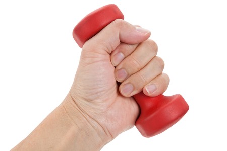 Hand holding a Red Dumbbell close up shotの写真素材