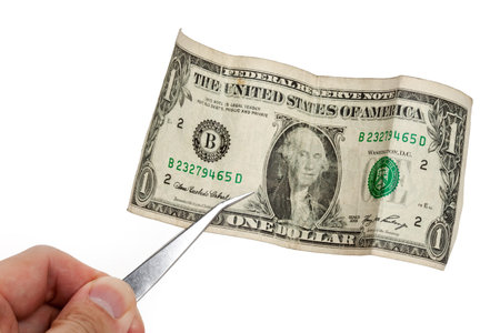 Metal Tweezers and Dollar close up shot