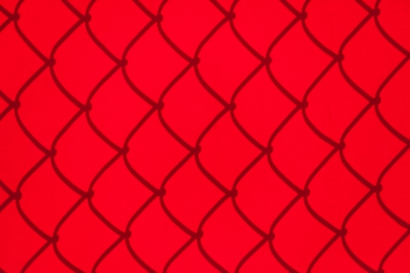 Chainlink Fence Shadow on red Shade Clothの写真素材