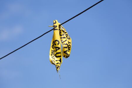 caution tape with blue skyの写真素材