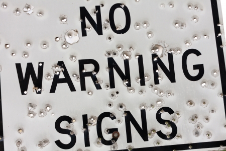Warning Sign with Bullet Holeの写真素材