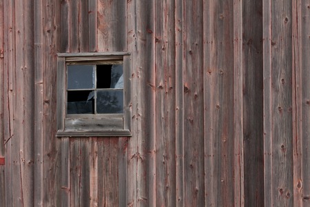 Windows on a very old wood buildingの写真素材
