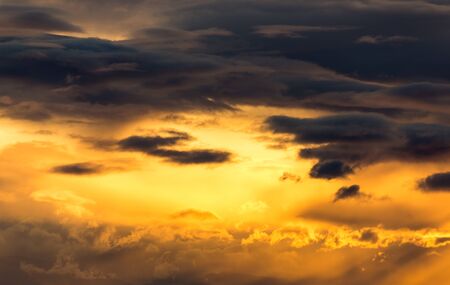 a vibrant orange and golden sunsetの写真素材