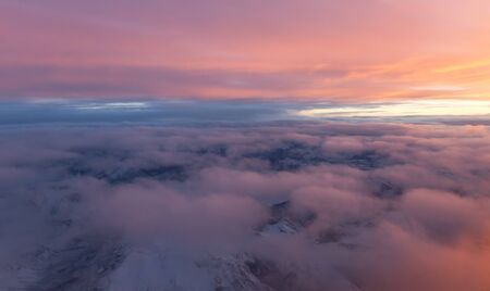 sunset viewed from an airplane over Canadian Rocky Mountainsの写真素材