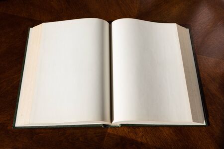Blank white pages in an open hardcover book.の写真素材