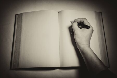 Blank white pages in an open hardcover book.の写真素材