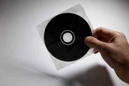 Hand holding a CD , DVD disk,  technology concept.の写真素材