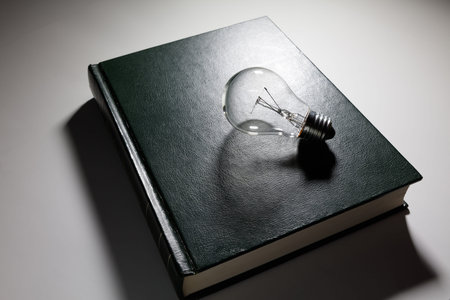 book and light bulb, business education concept.