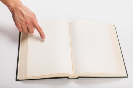 Blank white pages in an open hardcover book.の写真素材