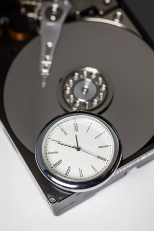 computer hard drive and clock, close up.
