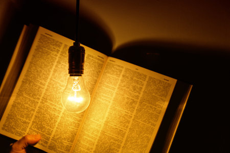 electric bulb illuminating a book