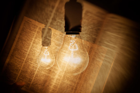 electric bulb illuminating a bookの写真素材