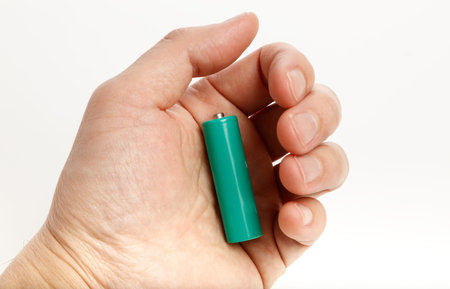 green battery with white background, close up