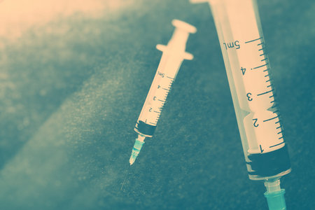 single use Medical syringe white dark background の写真素材